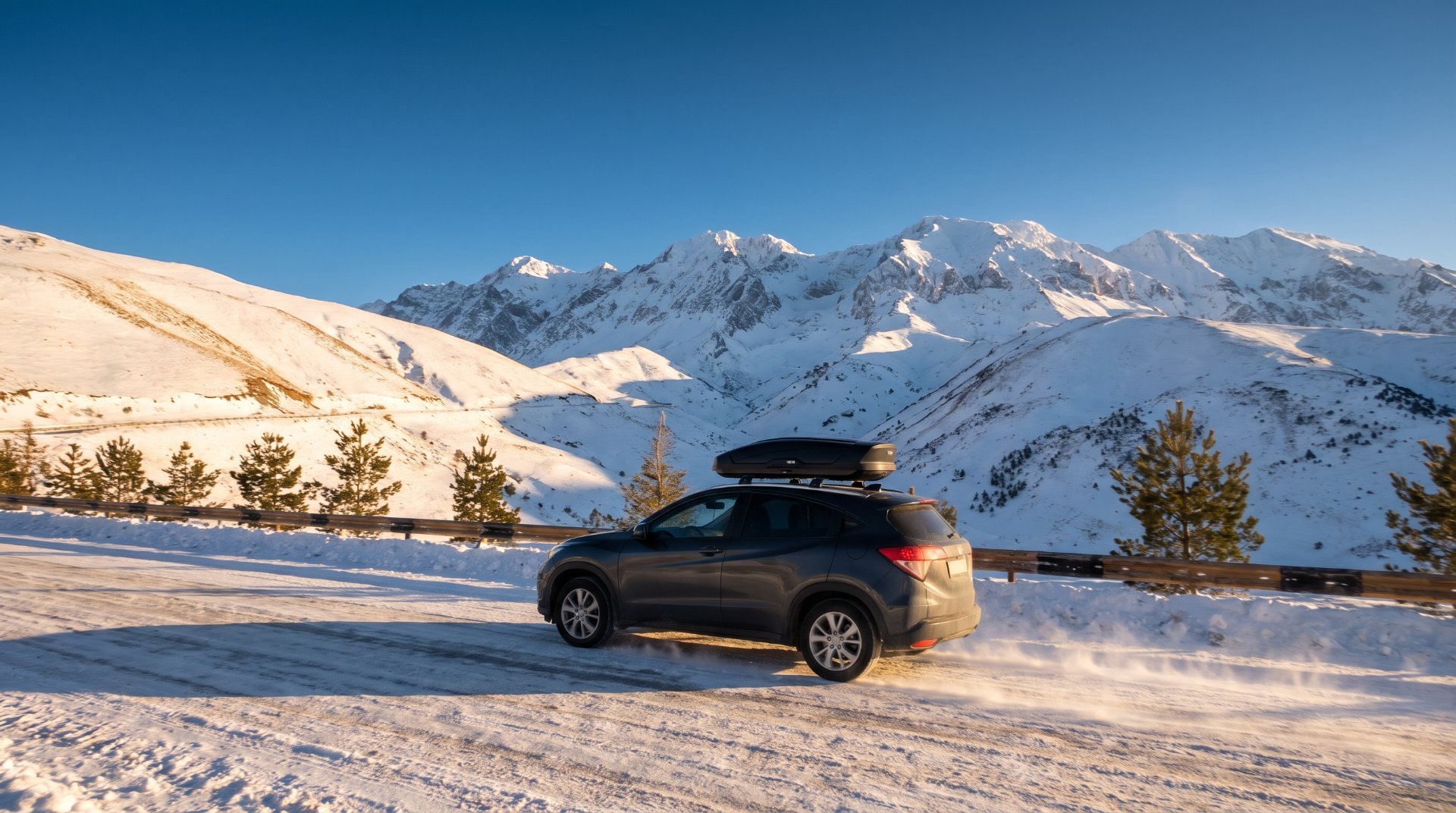 SUV with a ski roof box on a snowy mountain road to Shahdag, Azerbaijan